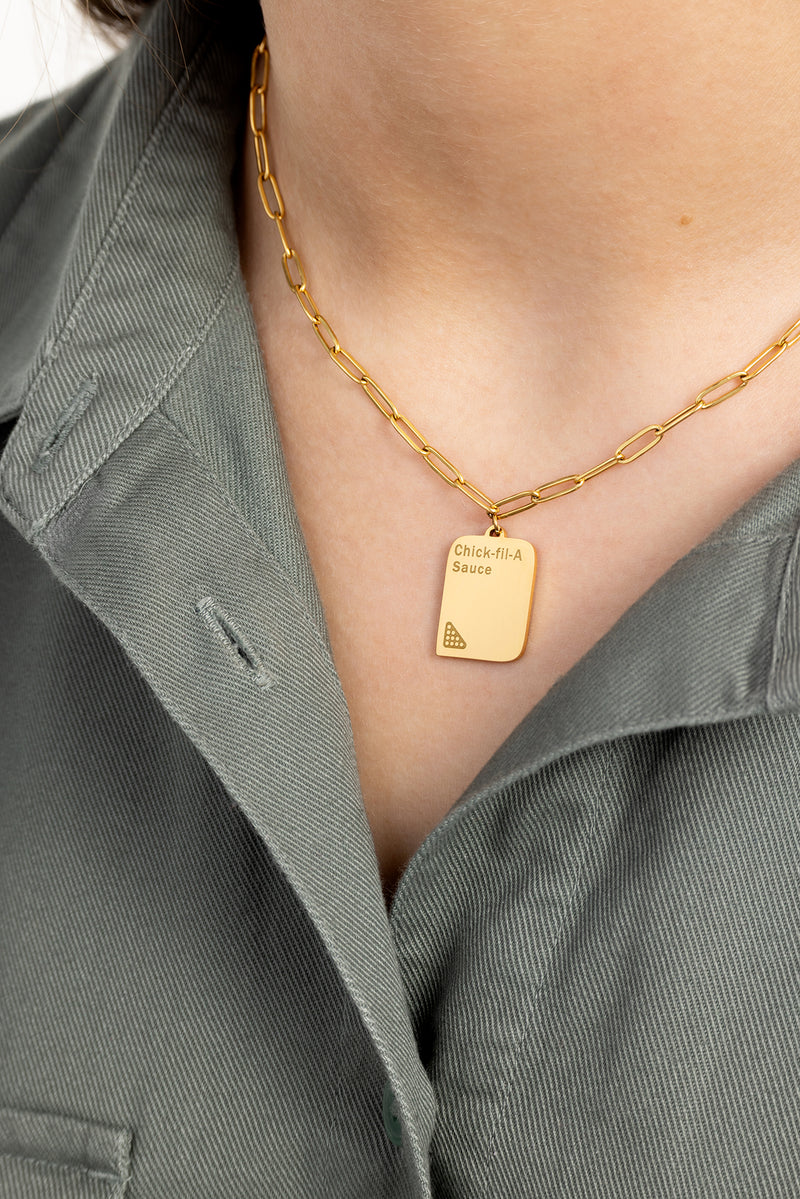 2-CFA_IHA_311050_HOL25_Merch_CFA-Sauce-Necklace_Talent_On-white_2.jpg